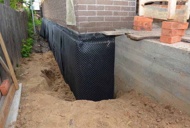 SJ Waterproofing Pros technician performing targeted Wet Basement Repair assessment in Oakdale, MN